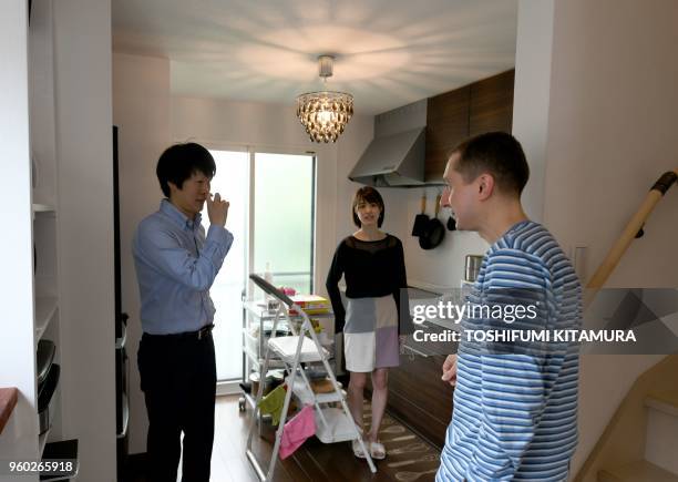 This May 12, 2018 picture shows room rental user Max Ikeda, a Ukrainian-Japanese living in Hiroshima , talking with rental house owner Nobuhide...