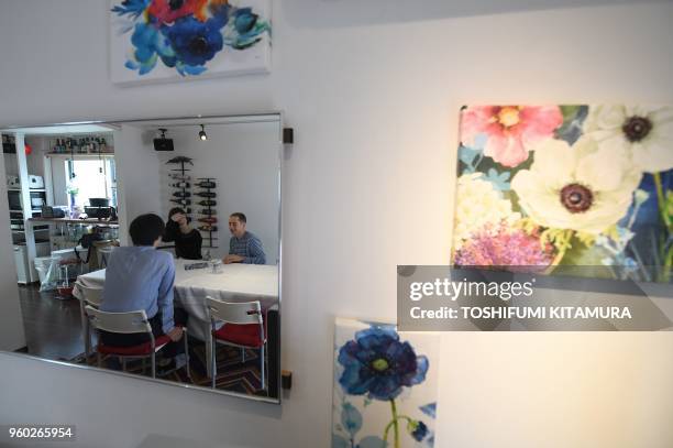 This May 12, 2018 picture shows room rental user Max Ikeda, a Ukrainian-Japanese living in Hiroshima , rental house owner Nobuhide Kaneda , and his...