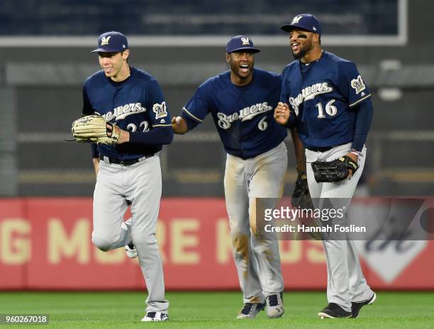 Christian Yelich, Lorenzo Cain and Domingo Santana of the Milwaukee Brewers celebrate defeating the against the Minnesota Twins 5-4 after the...