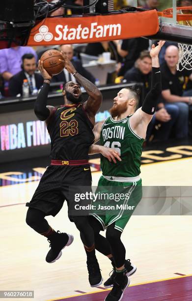 LeBron James of the Cleveland Cavaliers drives to the basket against Aron Baynes of the Boston Celtics in the second half during Game Three of the...
