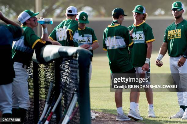 Rome Shubert , who was wounded in a mass shooting, speaks with teammates before a Santa Fe High School baseball makeup game a day after the mass...