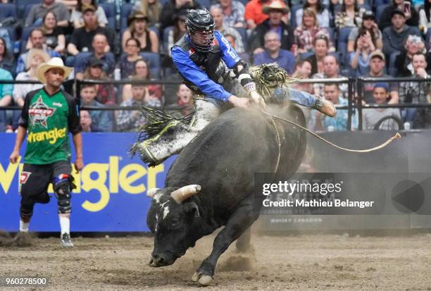 Justin Dakota Buttar rides Pop The Latch during the PBR Monster Energy Tour Professional Bull Riders event on May 19, 2018 at the Centre Videotron in...