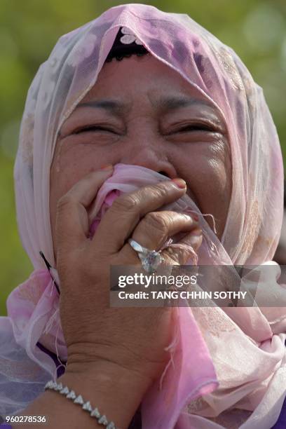 Woman cries while watching a performance by students to mark the annual 'Day of Anger' at the Choeung Ek memorial in Phnom Penh on May 20, 2018. -...