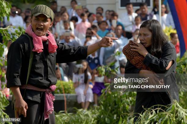 Students take part in a performance to mark the annual 'Day of Anger' at the Choeung Ek memorial in Phnom Penh on May 20, 2018. - Cambodians observed...