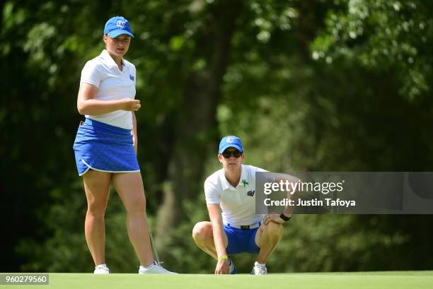 Olivia Reed of Grand Valley State looks at a putt with her coach Rebecca Mailloux during the Division II Women's Golf Championship held at Bay Oaks...