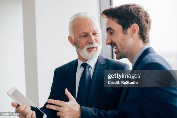 business people holding tablet and talking - order pad stock pictures, royalty-free photos & images