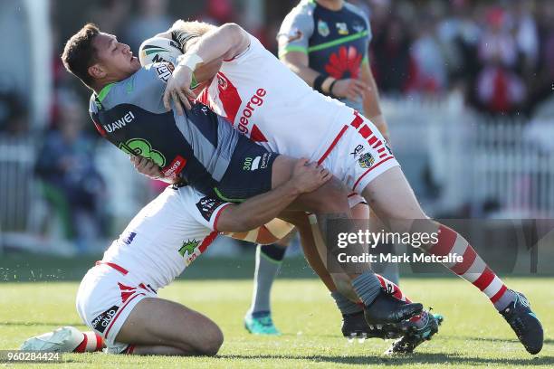 Josh Papalii of the Raiders is tackled by James Graham of the Dragons during the round 11 NRL match between the St George Illawarra Dragons and the...