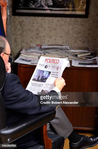 Man reads a copy of Politico in the Rayburn House Office Building in Washington, D.C. Politico is an American political journalism company based in...