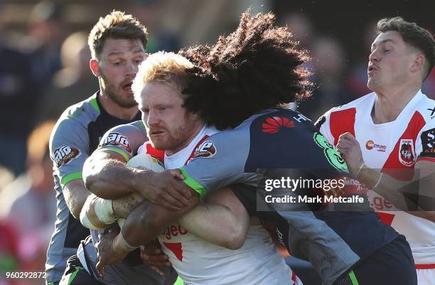 James Graham of the Dragons is tackled during the round 11 NRL match between the St George Illawarra Dragons and the Canberra Raiders at Glen Willow...