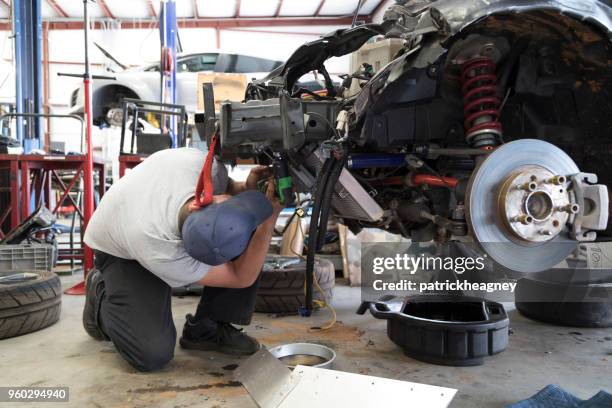 auto repair garage with mechanic - dismantling stock pictures, royalty-free photos & images