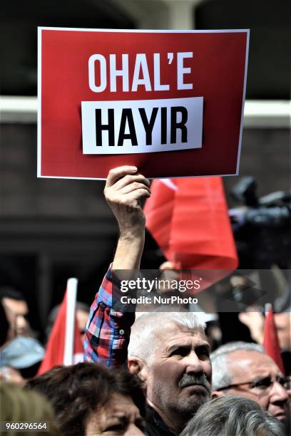 Man holds up a placard reading 'No to the state of emergency' during a demonstration staged by the main opposition Republican People's Party ,...
