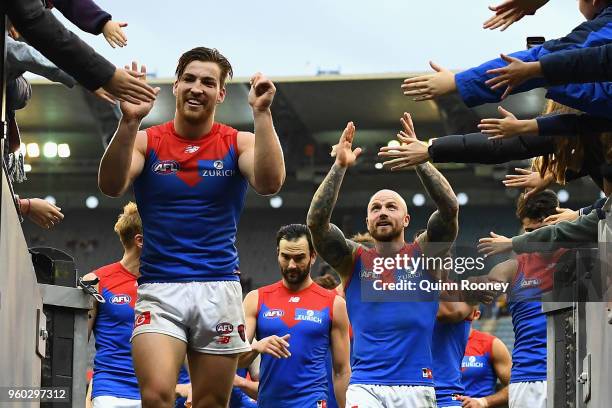 Jack Viney and Nathan Jones of the Demons lead their players off the field after winning the round nine AFL match between the Carlton Blues and the...