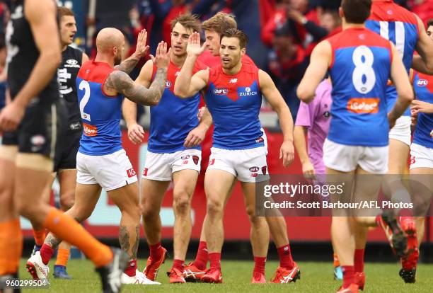 Jack Viney of the Demons is congratulated by Nathan Jones of the Demons and his teammates after kicking a goal during the round nine AFL match...