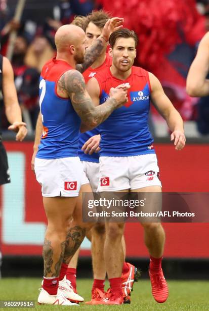 Jack Viney of the Demons is congratulated by Nathan Jones of the Demons and his teammates after kicking a goal during the round nine AFL match...