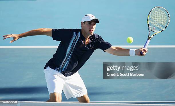 Carsten Ball of Australia plays a forehand in his second round doubles match with Stephen Huss of Australia against Fernando Gonzalez of Chile and...