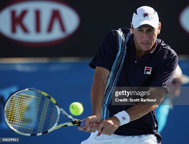 Carsten Ball of Australia plays a backhand in his second round doubles match with Stephen Huss of Australia against Fernando Gonzalez of Chile and...