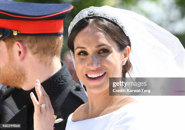 Meghan, Duchess of Sussex leaves Windsor Castle in the Ascot Landau carriage during a procession after getting married at St Georges Chapel on May...