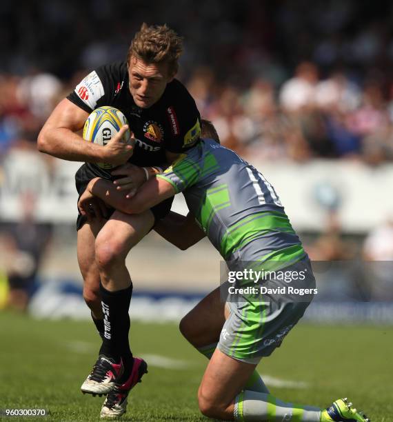 Lachie Turner of Exeter Chiefs is tackled by Toby Flood during the Aviva Premiership Semi Final between Exeter Chiefs and Newcastle Falcons at Sandy...