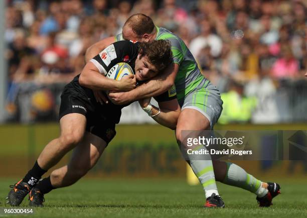 Alec Hepburn of Exeter is tackled by Kyle Cooper during the Aviva Premiership Semi Final between Exeter Chiefs and Newcastle Falcons at Sandy Park on...
