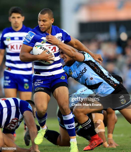 Moses Mbye of the Bulldogs is tackled by Valentine Holmes of the Sharks during the round 11 NRL match between the Cronulla Sharks and the Canterbury...