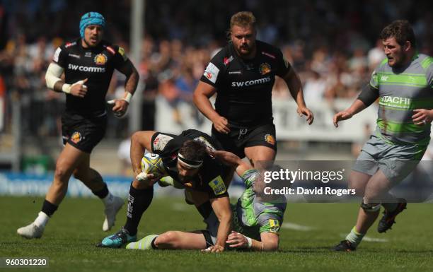Don Armand of Exeter is tackled by Micky Young during the Aviva Premiership Semi Final between Exeter Chiefs and Newcastle Falcons at Sandy Park on...