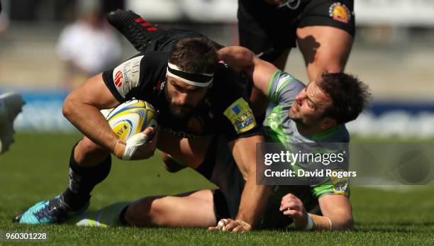 Don Armand of Exeter is tackled by Micky Young during the Aviva Premiership Semi Final between Exeter Chiefs and Newcastle Falcons at Sandy Park on...