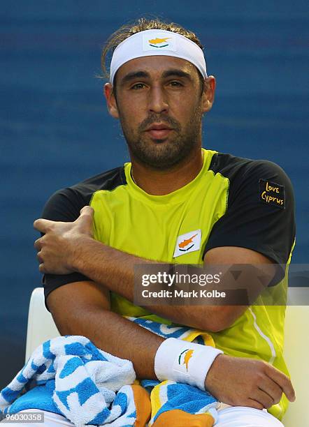 Marcos Baghdatis of Cyprus sits in his players seat between games in his third round match against Lleyton Hewitt of Australia during day six of the...