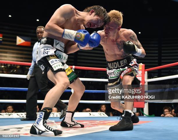 South Africa's Hekkie Budler punches Japan's Ryoichi Taguchi during their IBF, WBA world light flyweight unification title boxing bout in Tokyo on...