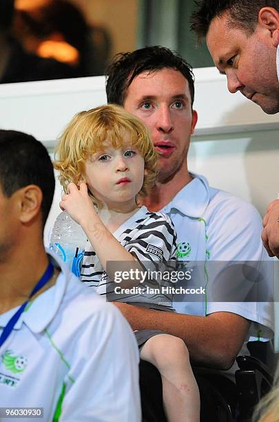 Robbie Fowler of the Fury sits in the grandstand with his son Jacob during the round 24 A-League match between the North Queensland Fury and the...