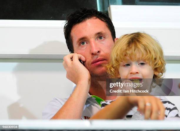 Robbie Fowler of the Fury sits in the grandstand with his son Jacob during the round 24 A-League match between the North Queensland Fury and the...