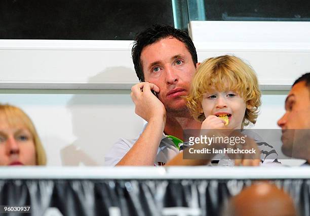 Robbie Fowler of the Fury sits in the grandstand with his son Jacob during the round 24 A-League match between the North Queensland Fury and the...