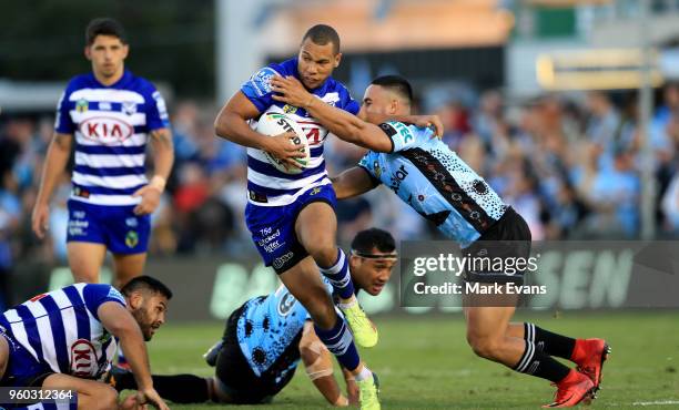 Moses Mbye of the Bulldogs is tackled by Valentine Holmes of the Sharks during the round 11 NRL match between the Cronulla Sharks and the Canterbury...