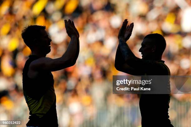 Jack Riewoldt and Dustin Martin of the Tigers high five at the half time break during the round nine AFL match between the West Coast Eagles and the...