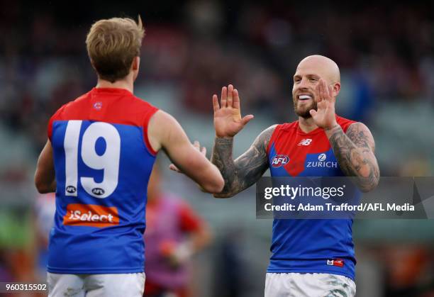 Nathan Jones of the Demons congratulates Mitch Hannan of the Demons on a goal during the 2018 AFL round nine match between the Carlton Blues and the...