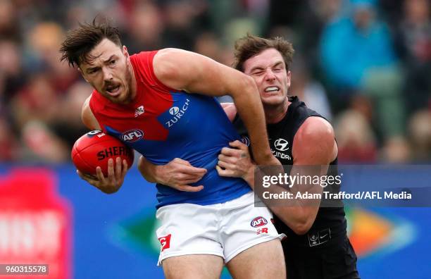 Michael Hibberd of the Demons is tackled by Jed Lamb of the Blues during the 2018 AFL round nine match between the Carlton Blues and the Melbourne...