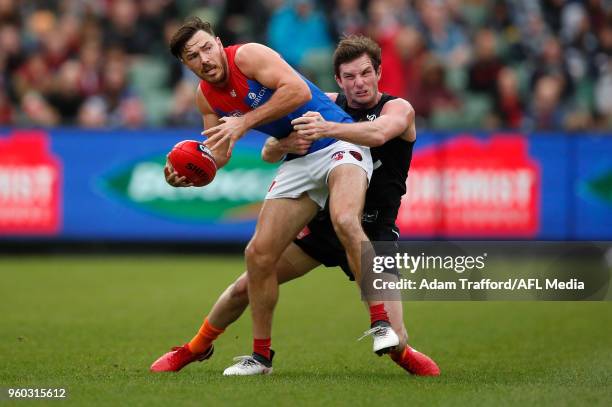 Michael Hibberd of the Demons is tackled by Jed Lamb of the Blues during the 2018 AFL round nine match between the Carlton Blues and the Melbourne...