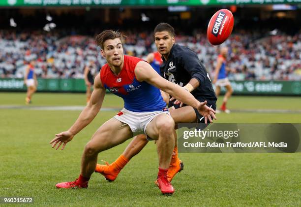 Jack Viney of the Demons and Sam Petrevski-Seton of the Blues compete for the ball during the 2018 AFL round nine match between the Carlton Blues and...