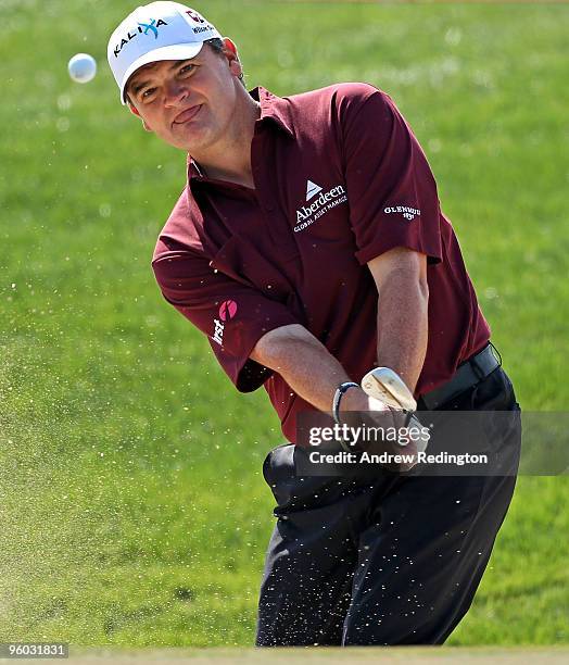 Paul Lawrie of Scotland plays a bunker shot on the third hole during the third round of The Abu Dhabi Golf Championship at Abu Dhabi Golf Club on...