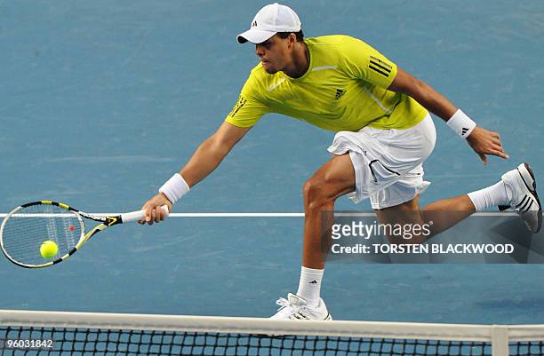 French tennis player Jo Wilfried Tsonga plays a forehand return during his third round men's singles match against German opponent Tommy Haas at the...