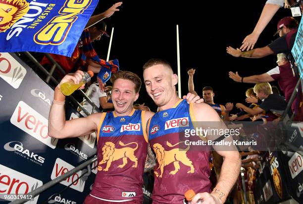 Dayne Beams of the Lions and Alex Witherden celebrate victory after the round nine AFL match between the Brisbane Lions and the Hawthorn Hawks at The...