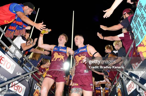 Dayne Beams of the Lions and Alex Witherden celebrate victory after the round nine AFL match between the Brisbane Lions and the Hawthorn Hawks at The...