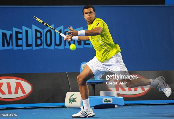 French tennis player Jo Wilfried Tsonga plays a forehand return during his third round men's singles match against German opponent Tommy Haas at the...