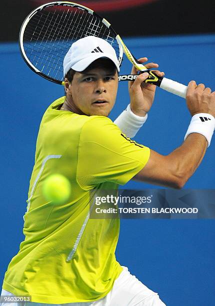 French tennis player Jo Wilfried Tsonga plays a backhand return during his third round men's singles match against German opponent Tommy Haas at the...