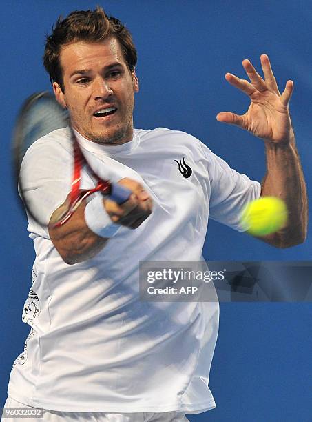 German tennis player Tommy Haas plays a forehand return during his third round men's singles match against French opponent Jo Wilfried Tsonga at the...