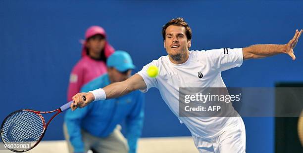 German tennis player Tommy Haas stretches to play a forehand return during his third round men's singles match against French opponent Jo Wilfried...