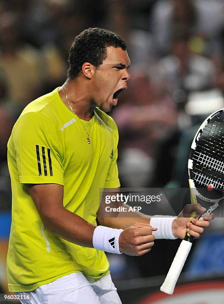 French tennis player Jo Wilfried Tsonga celebrates winning a point during his third round men's singles match against German opponent Tommy Haas at...