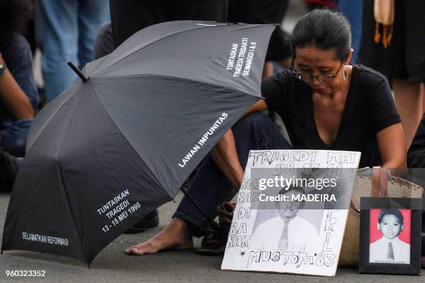 In this photograph taken on May 17, 2018 an activist attends a rally in front of the presidential palace in Jakarta, demanding justice over deaths...