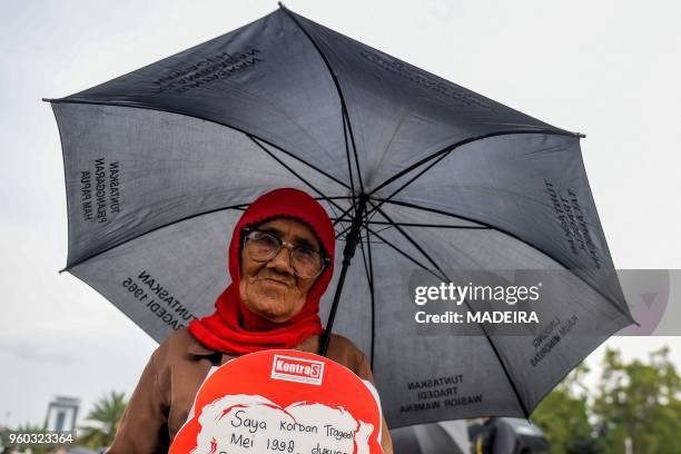 In this photograph taken on May 17, 2018 an activist attends a rally in front of the presidential palace in Jakarta, demanding justice over deaths...