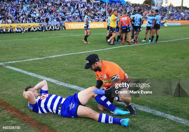 Josh Morris of the Bulldogs goes down with an injury during the round 11 NRL match between the Cronulla Sharks and the Canterbury Bulldogs at...