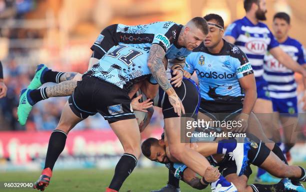 David Klemmer of the Bulldogs is tackled by josh Dugan and Kurt Capewell of the Sharks during the round 11 NRL match between the Cronulla Sharks and...